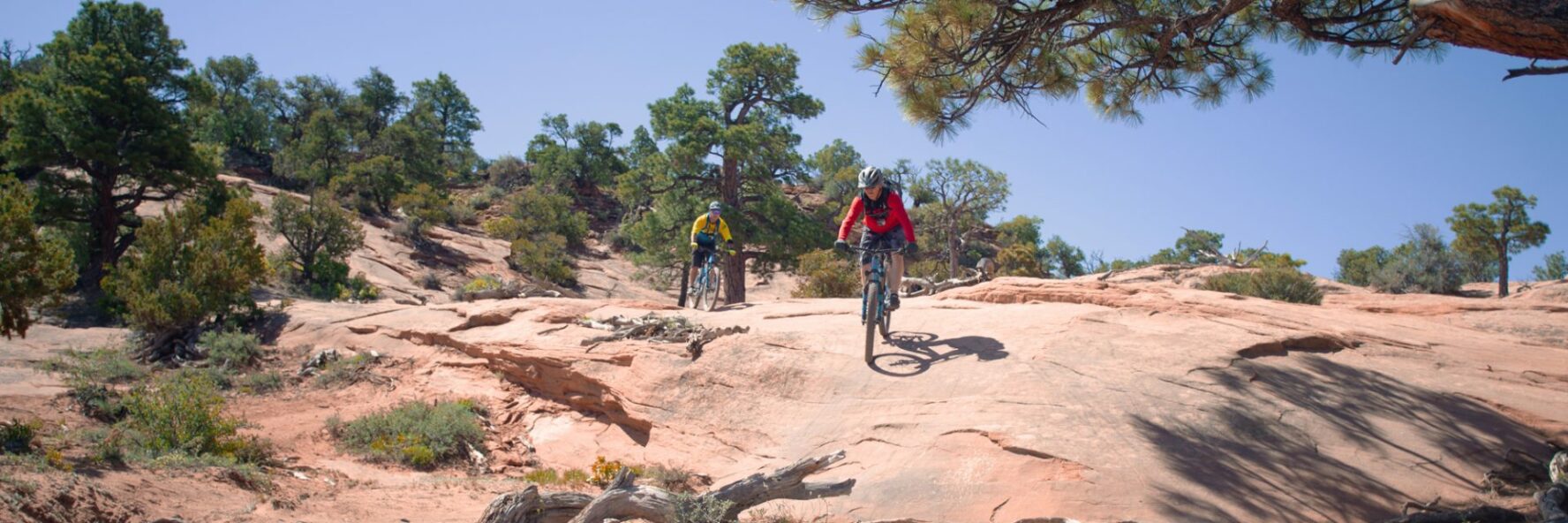 Two riders descending a rock on the Porcupine Rim