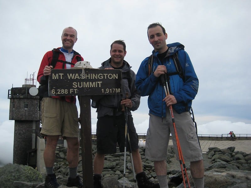 Hikers celebrating their climb to Mt. Washington on the Presidential Traverse