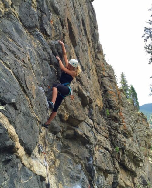 A woman climbing a cliff in Colorado