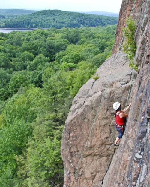 A woman climbing a cliff in Connecticut