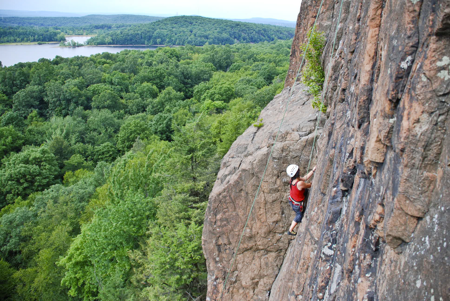 A woman climbing a cliff in Connecticut