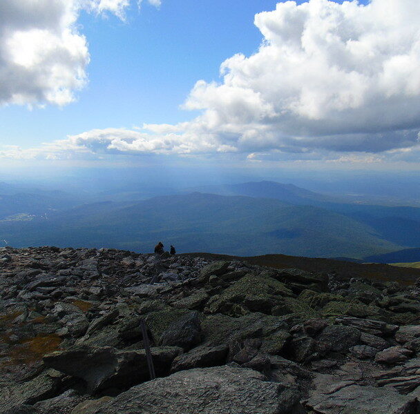 Man standing on the Mount Washington Summit
