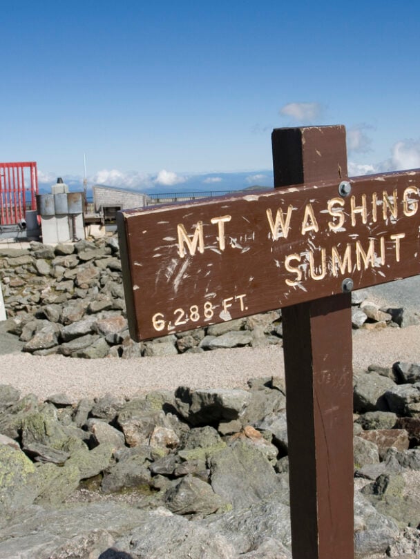 Man standing on the Mount Washington Summit