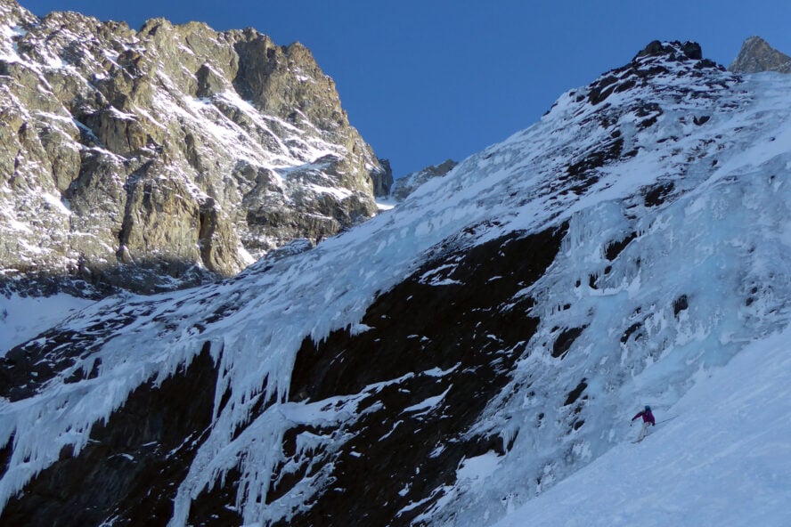 My friend Amandine skiing Zone Interdite in the shadow of la Meije in la Grave