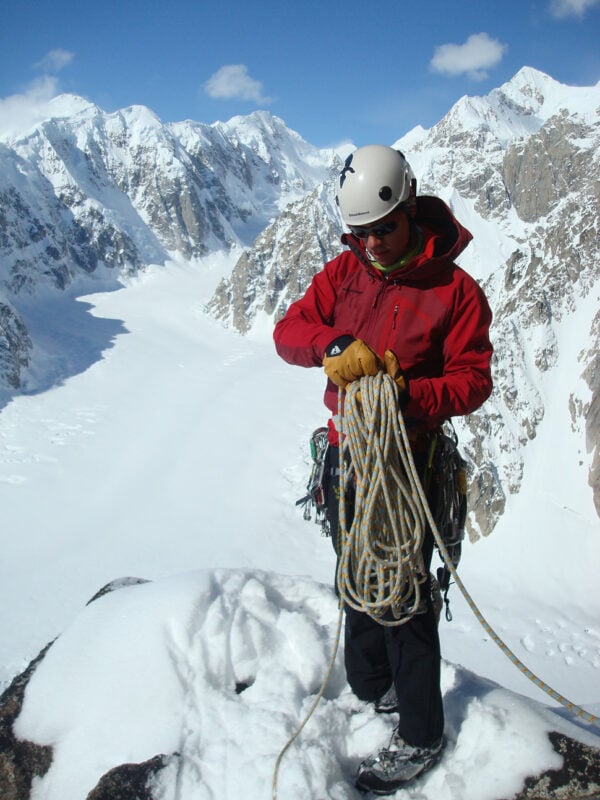 A mountaineer dealing with a rope in the Alaska Range