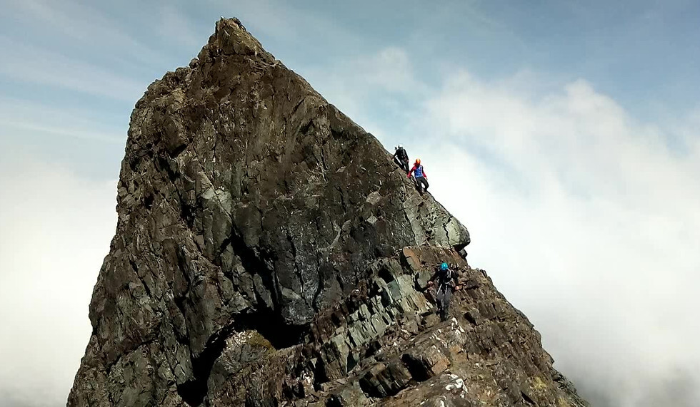 Climbers on a peak in Cuillin Ridge