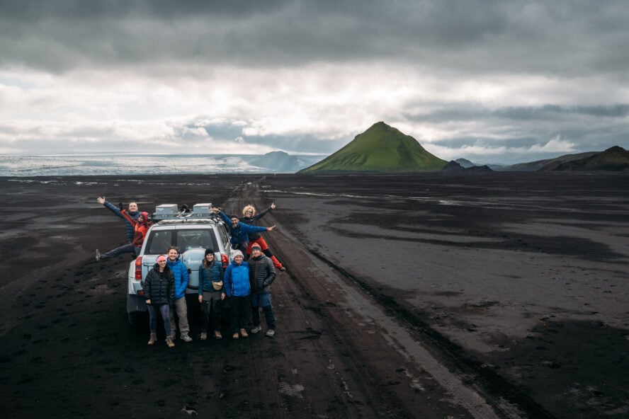 Or group posing for a photo in front of the Maelifell volcano.