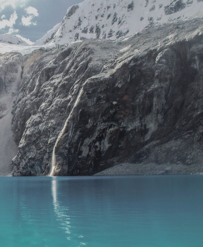 A lake beneath a cliff in Peru