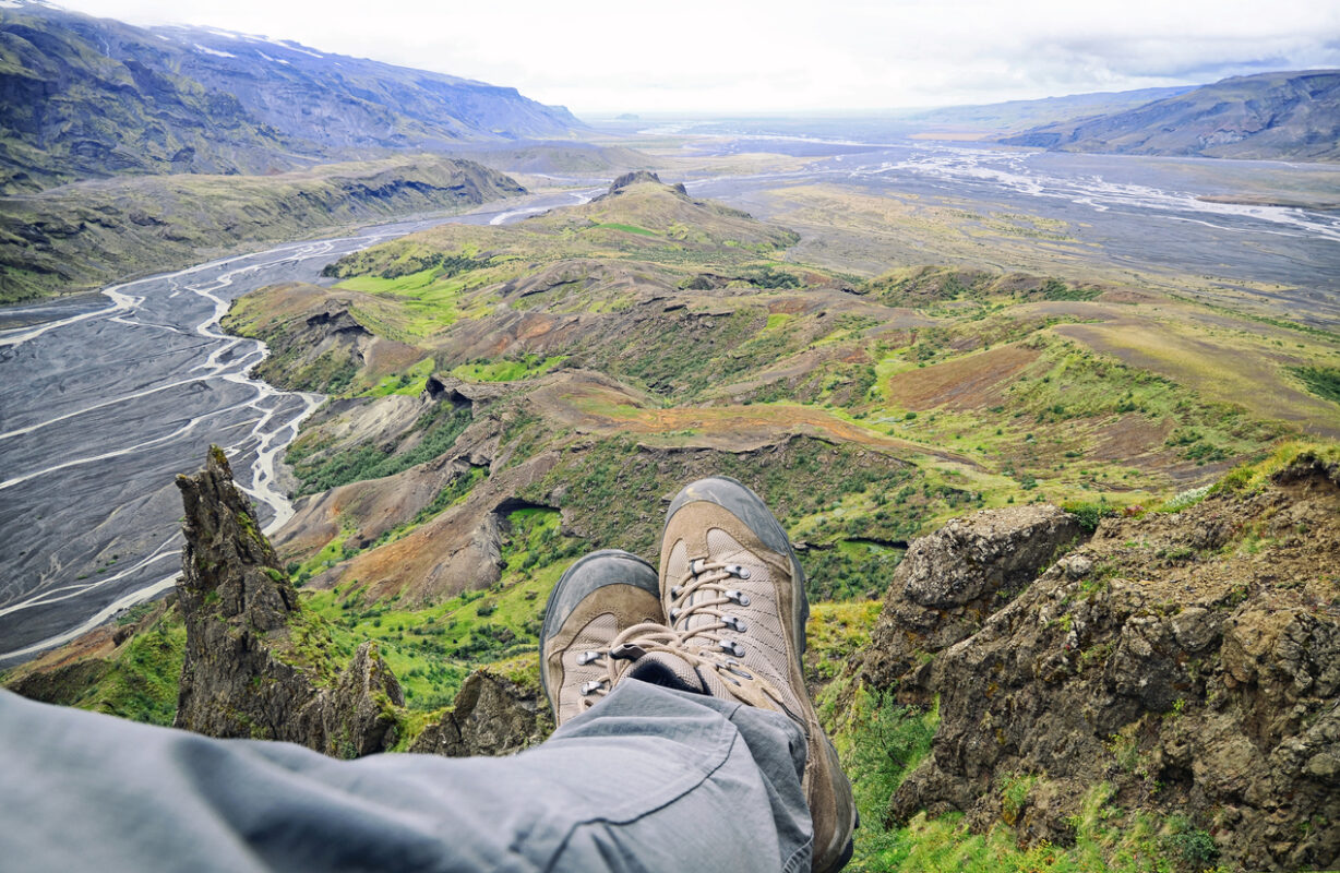 A person relaxing in front of a valley in Thorsmork
