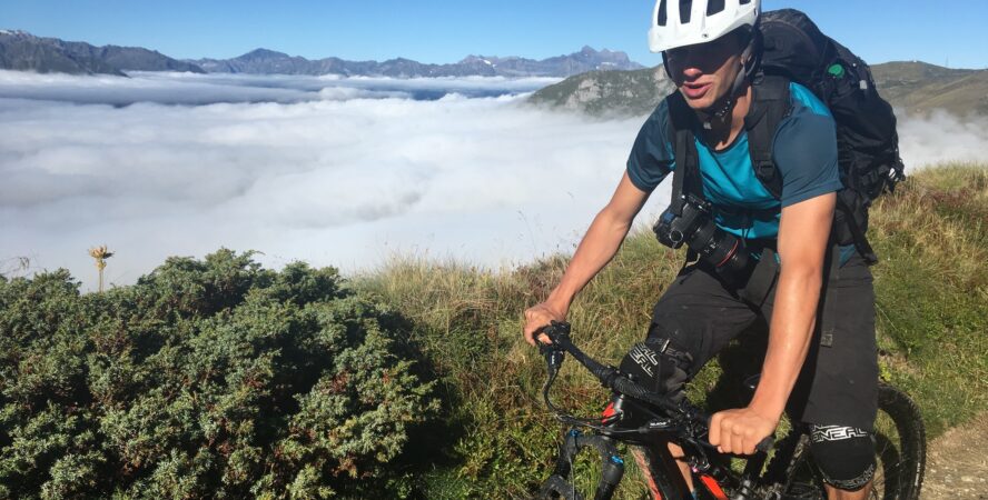 My friend and adventure photographer (often my personal photographer) mountain biking in the Alps above the clouds.