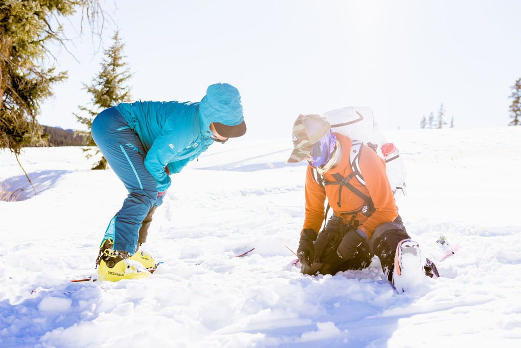 A couple of skiers learning about avy rescue in San Juan Mountains, Colorado