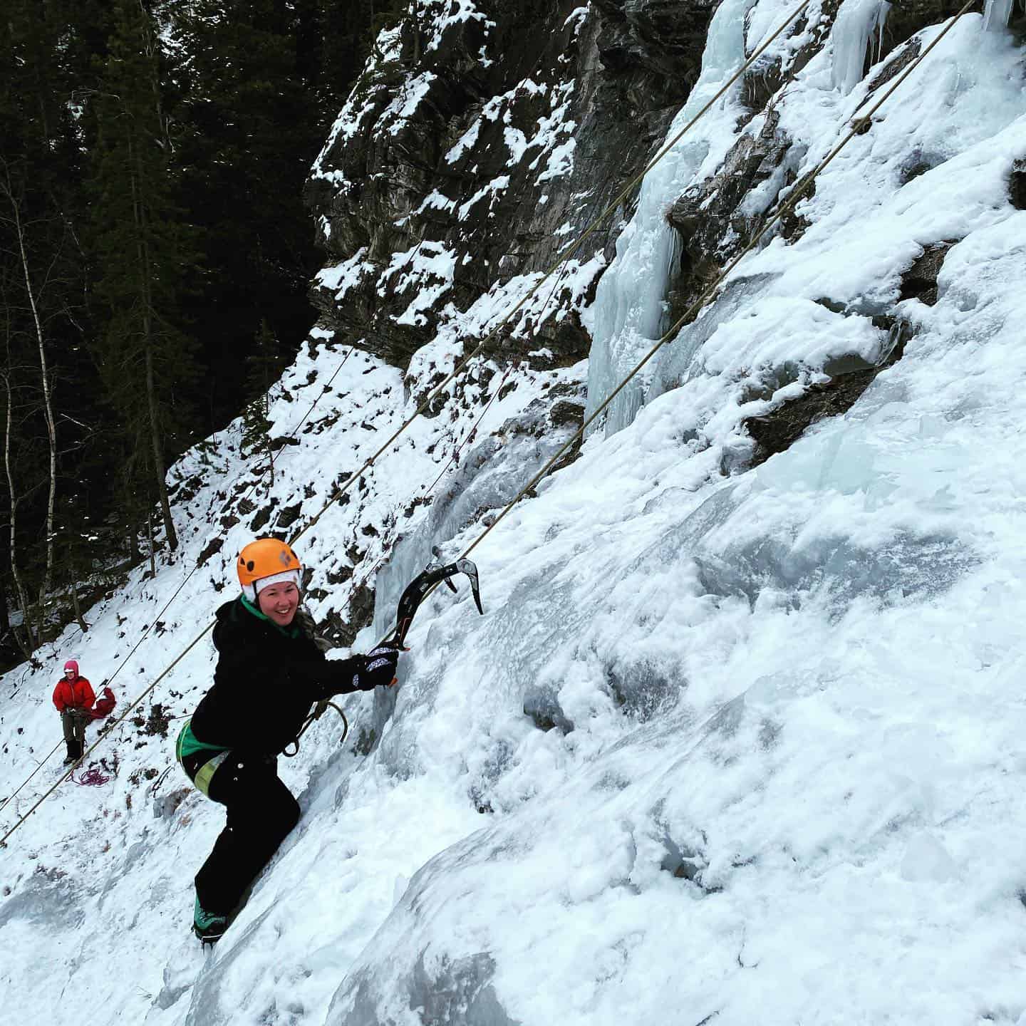 A climber smiling at the camera in the Canadian Rockies