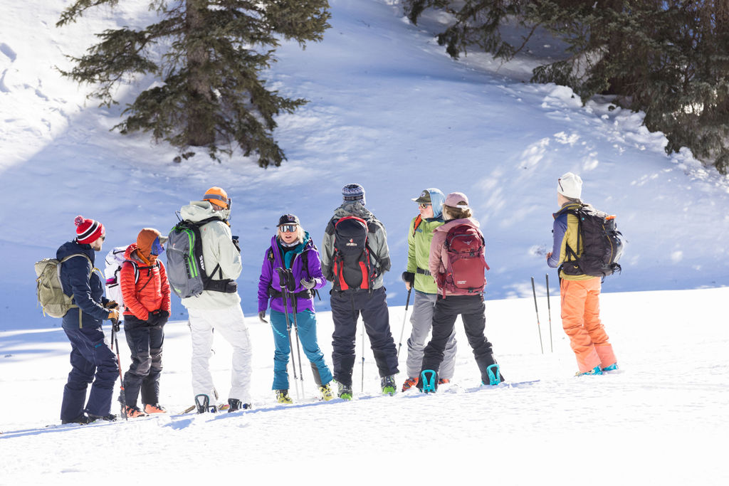 A group learning about avalanche rescue in the field