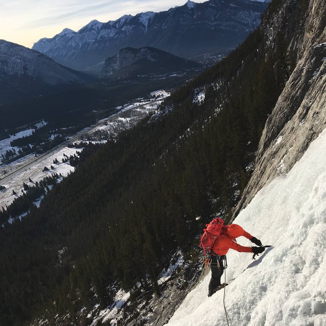 An ice climber and the surrounding scenery in the Canadian Rockies