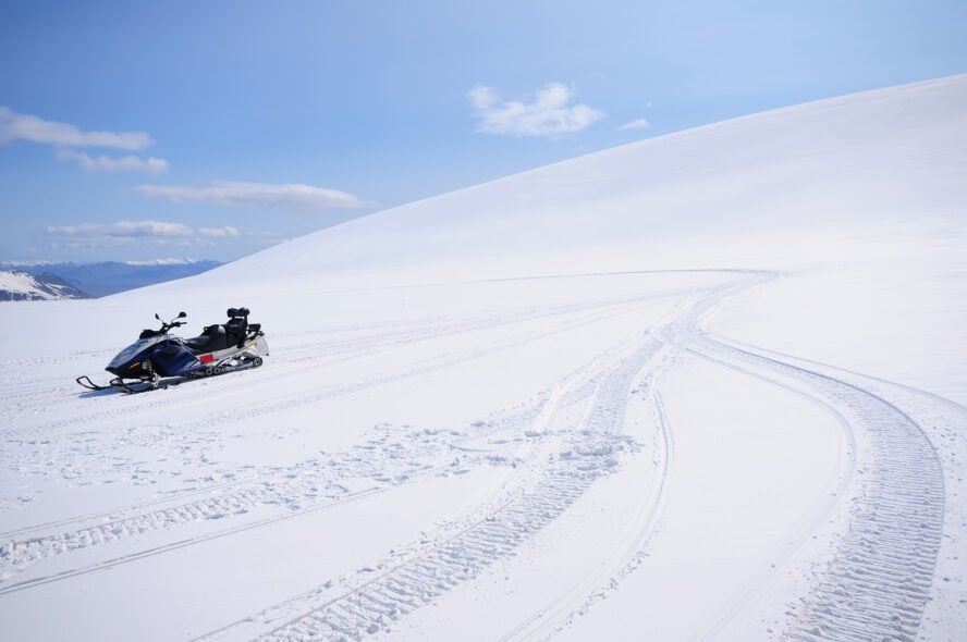 A lone snowmobile on a snow-covered slope of the Vatnajökull glacier in Iceland