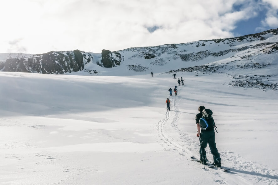  A group of skiers ascending a snow-covered mountain in Iceland