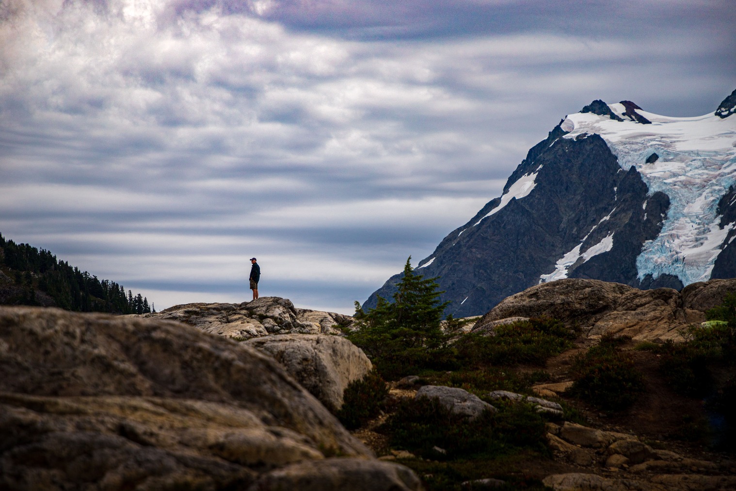 Free Photo  A traveler's hand with a compass over a scenic view