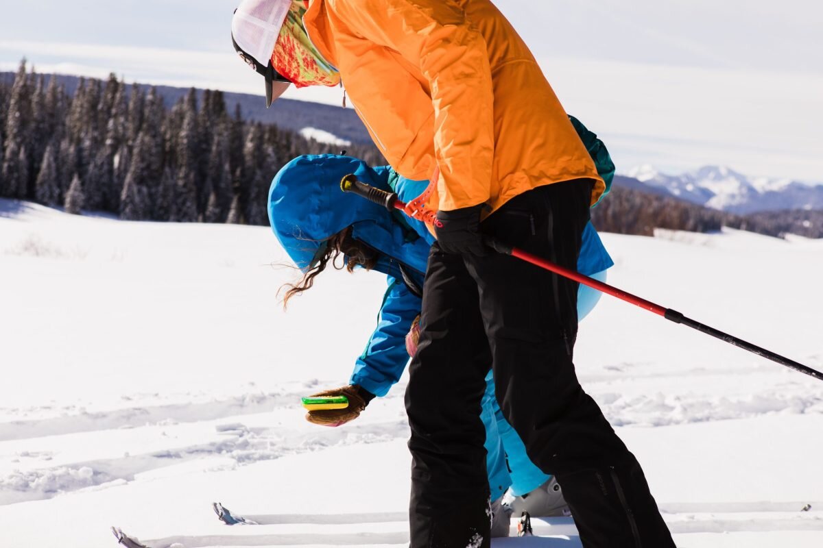 Avalanche rescue course participants using a transceiver in the San Juan Mountains