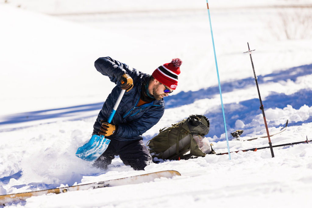 Shoveling snow during an avy rescue course in San Juan Mountains in Colorado