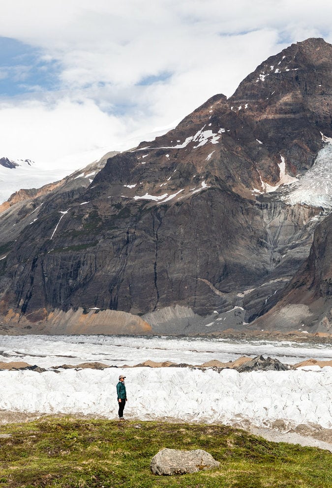 A man observing glaciers and moraines while hiking in Denali National Park and Preserve