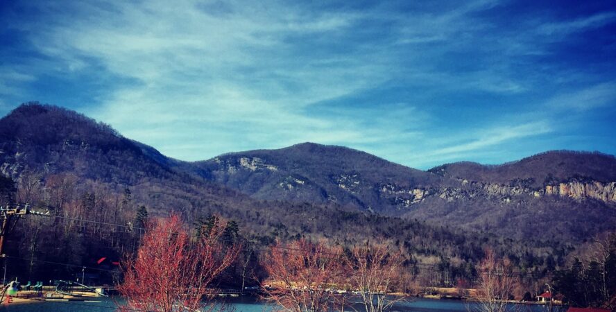 The Rumbling Bald crags as seen from Lake Lure in autumn.