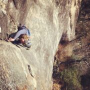 Slotting protection into Gemini Crack a 5.8 crack climb on the South Side of Looking Glass Rock. Photo courtesy of Amanda Ellis.