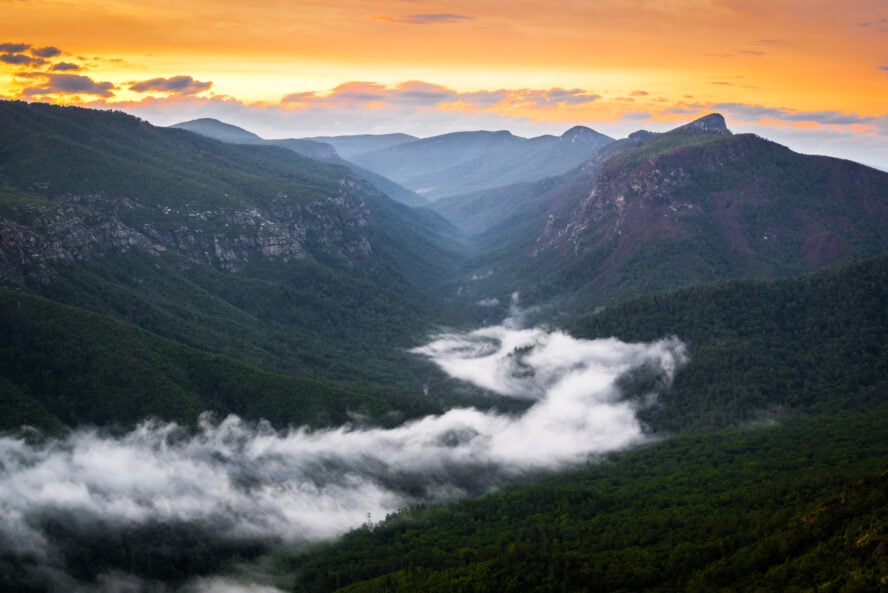 Low hanging clouds and a surreal Linville Gorge sunset after a day of rock climbing in North Carolina