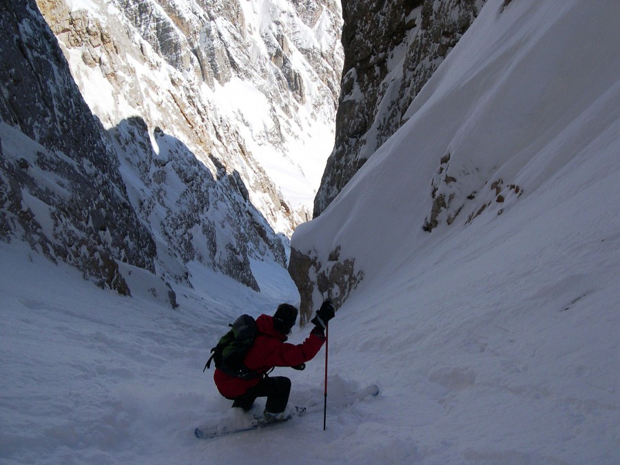 A backcountry skier descending in the Dolomites