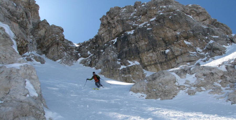  A backcountry skier making turns in the Dolomites