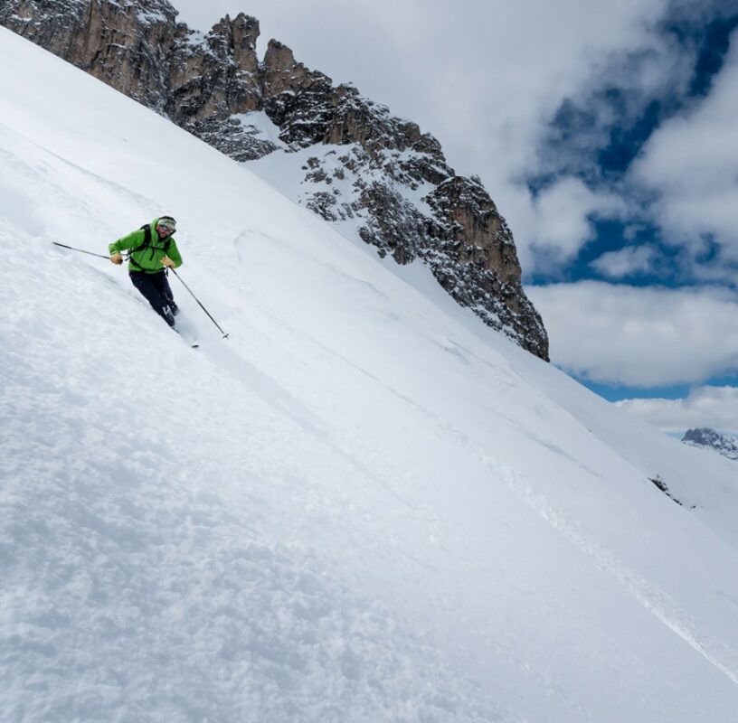 A backcountry skier shredding the snow in the Dolomites