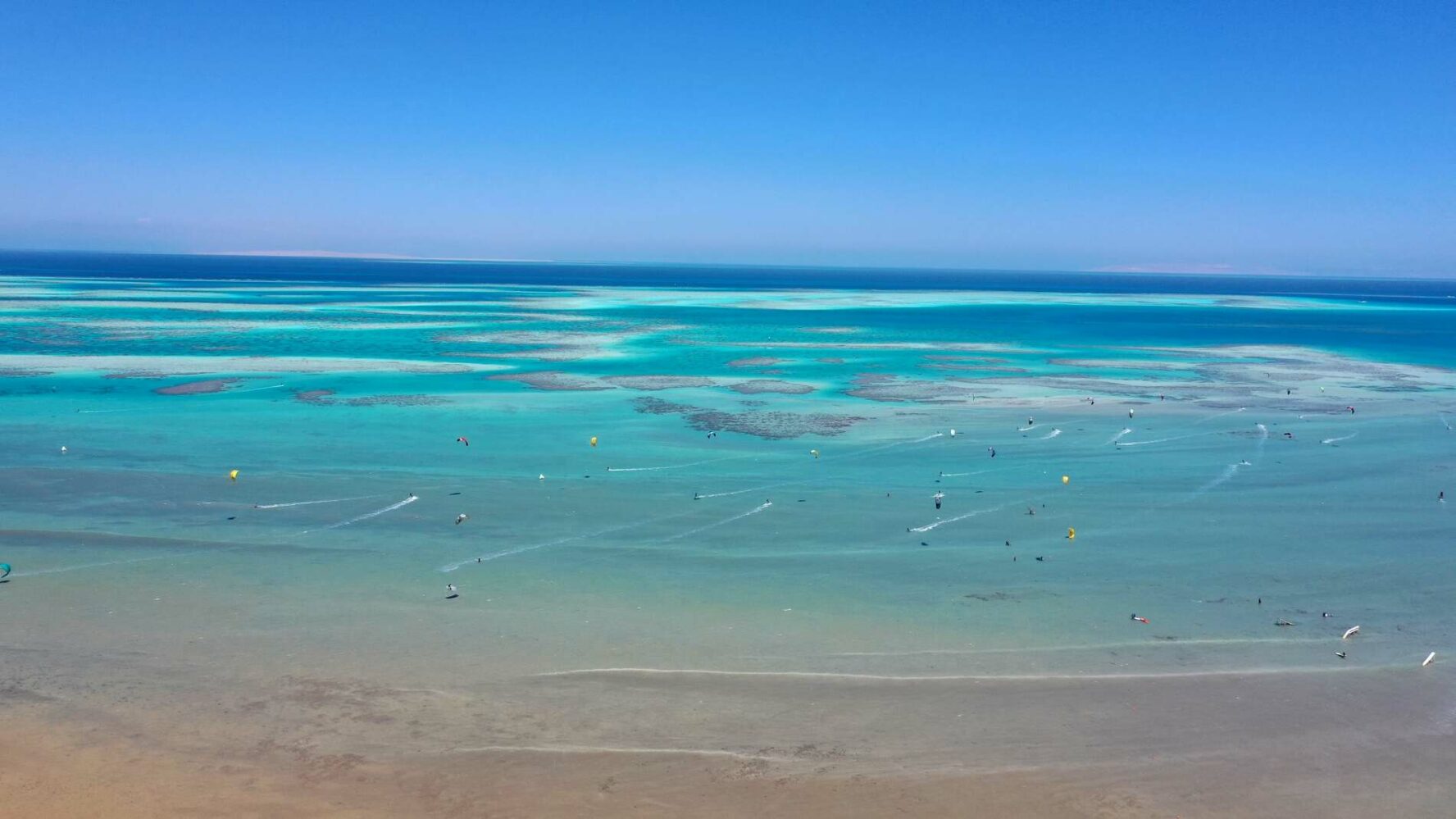 A beautiful aerial view of sea and kitesurfers