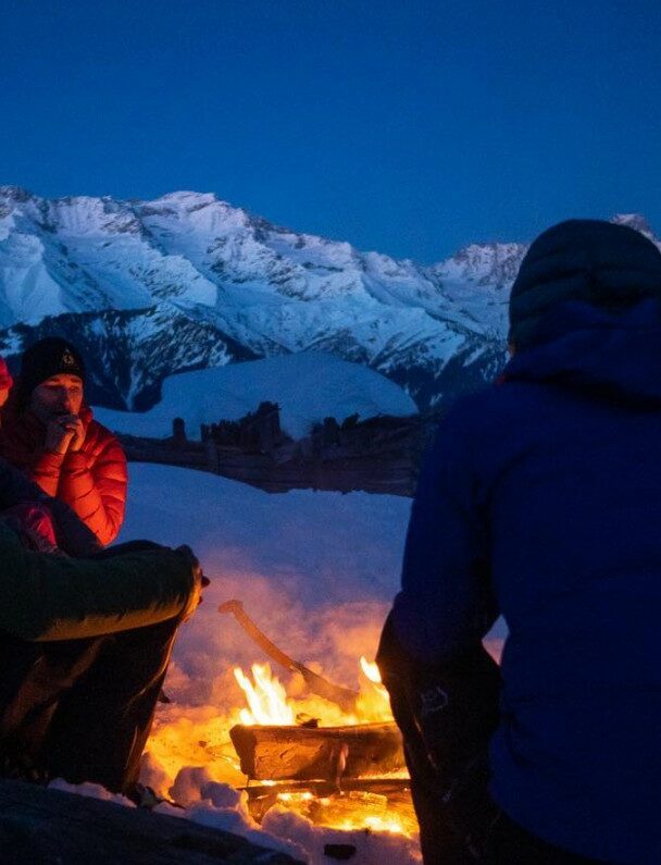 A lofty sniw-dusted mountain peak in the Georgian region of racha traversed by backcountry skiers