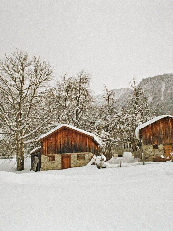 A lofty sniw-dusted mountain peak in the Georgian region of racha traversed by backcountry skiers
