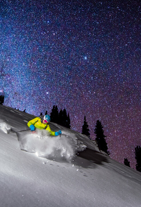 Nights in Revelstoke can be so bright that you can even ski and shred some powder