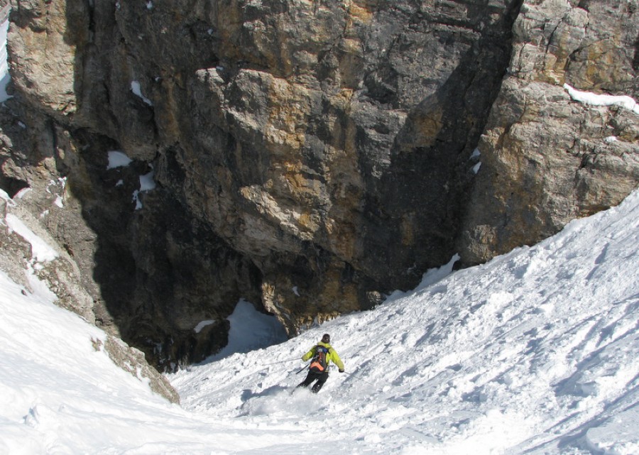 Skier on a steep descent in the Dolomites