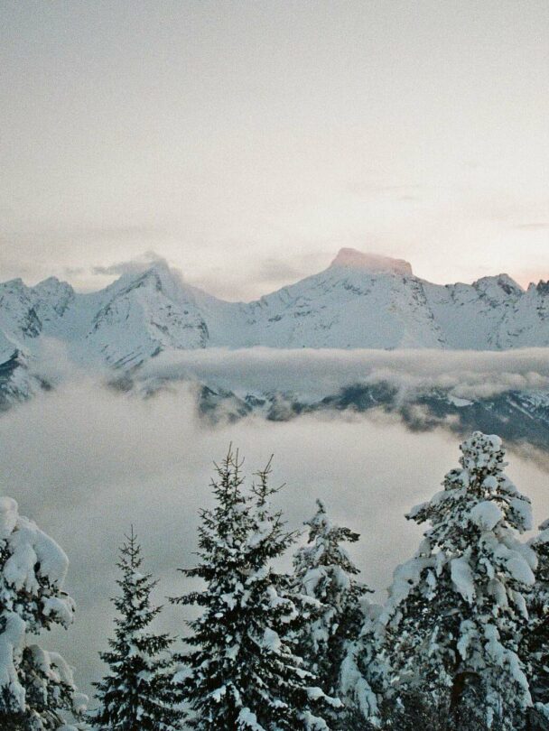 A lofty sniw-dusted mountain peak in the Georgian region of racha traversed by backcountry skiers