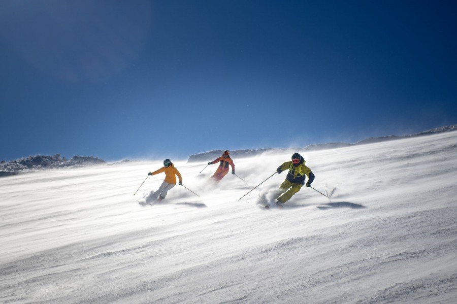 Three skiers in the Dolomites in the Alps