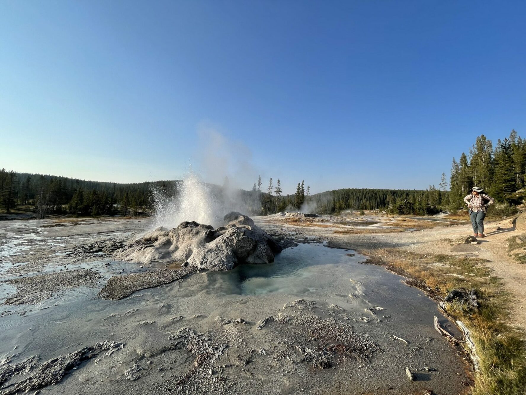 A woman next to Shoshone Geyser Basin
