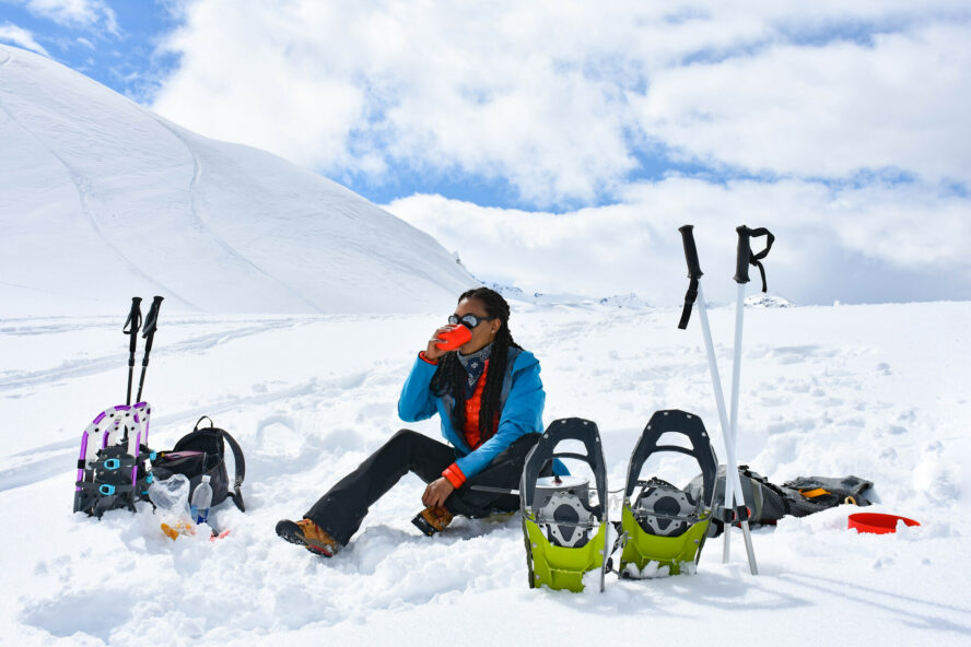 The author warms up with a warm cup of tea on a winter snowshoe hike at Artist Point.