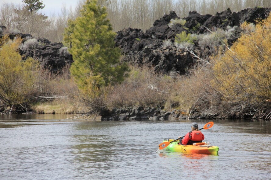 Kayaking beside a lava flow on the Upper Deschutes River, outside Bend, Oregon. 