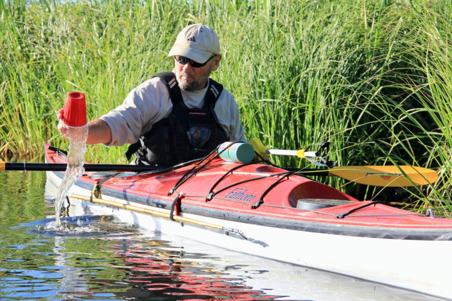 Cleaning up the river by kayak on the Deschutes River, Bend, Oregon. 