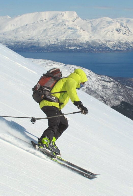 Skier shredding through Lyngen Alps