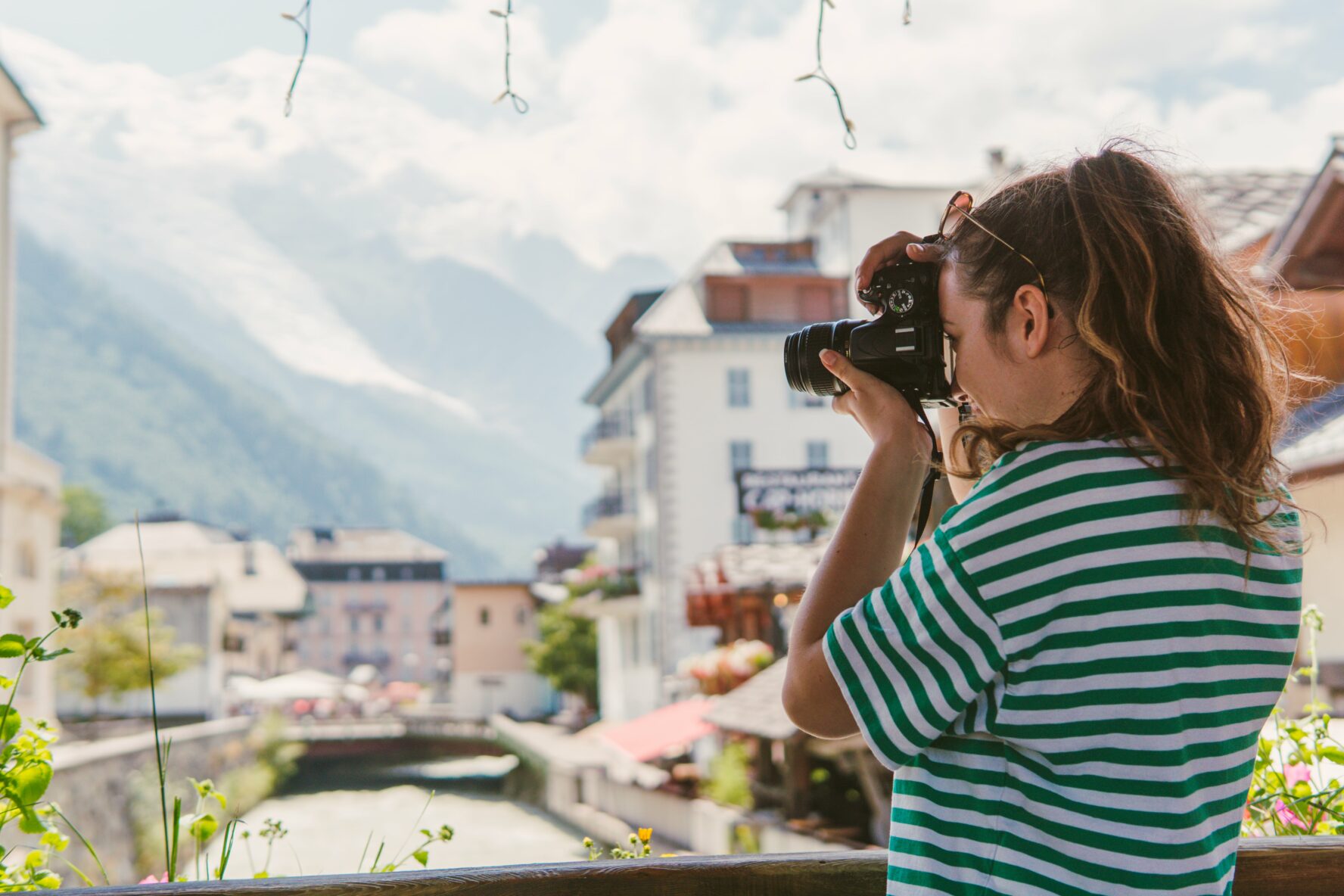 A photographer taking a photo on a bridge in Chamonix.