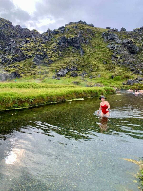 The girl with the hat in the hot spring Iceland