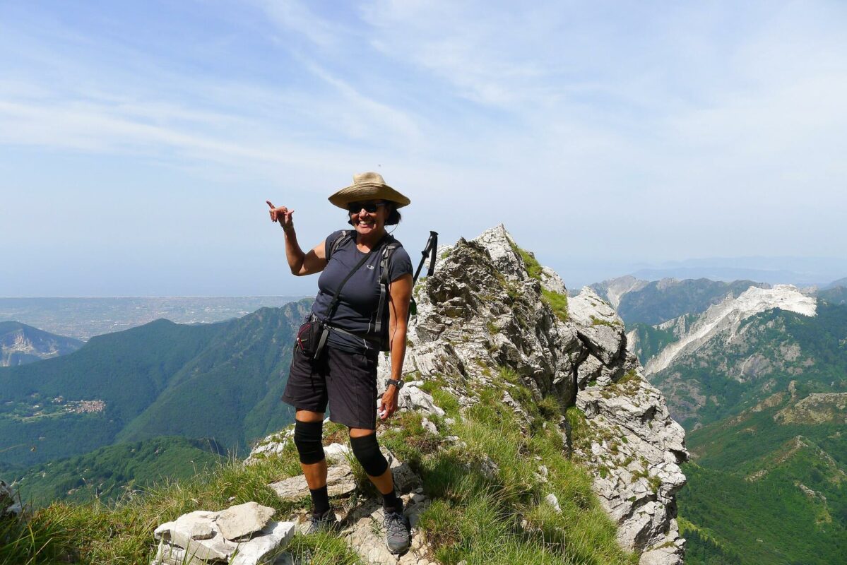 A hiker posing for a photo in Tuscany