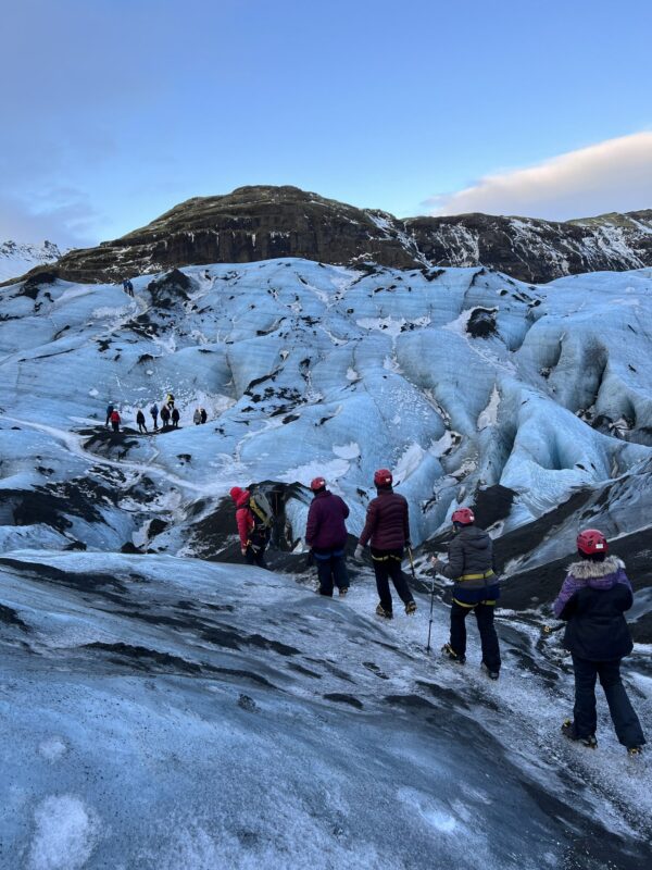 Hikers walking on ice in Iceland