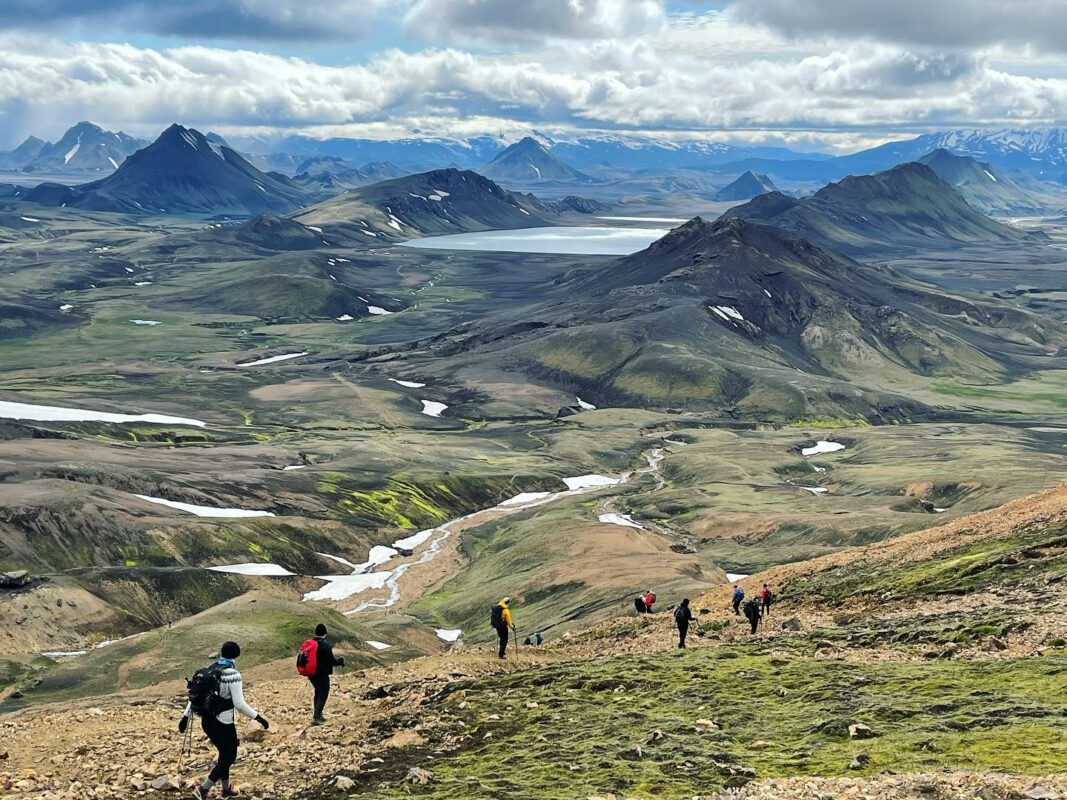 A view of some meadows and hikers on the Laugavegur trail