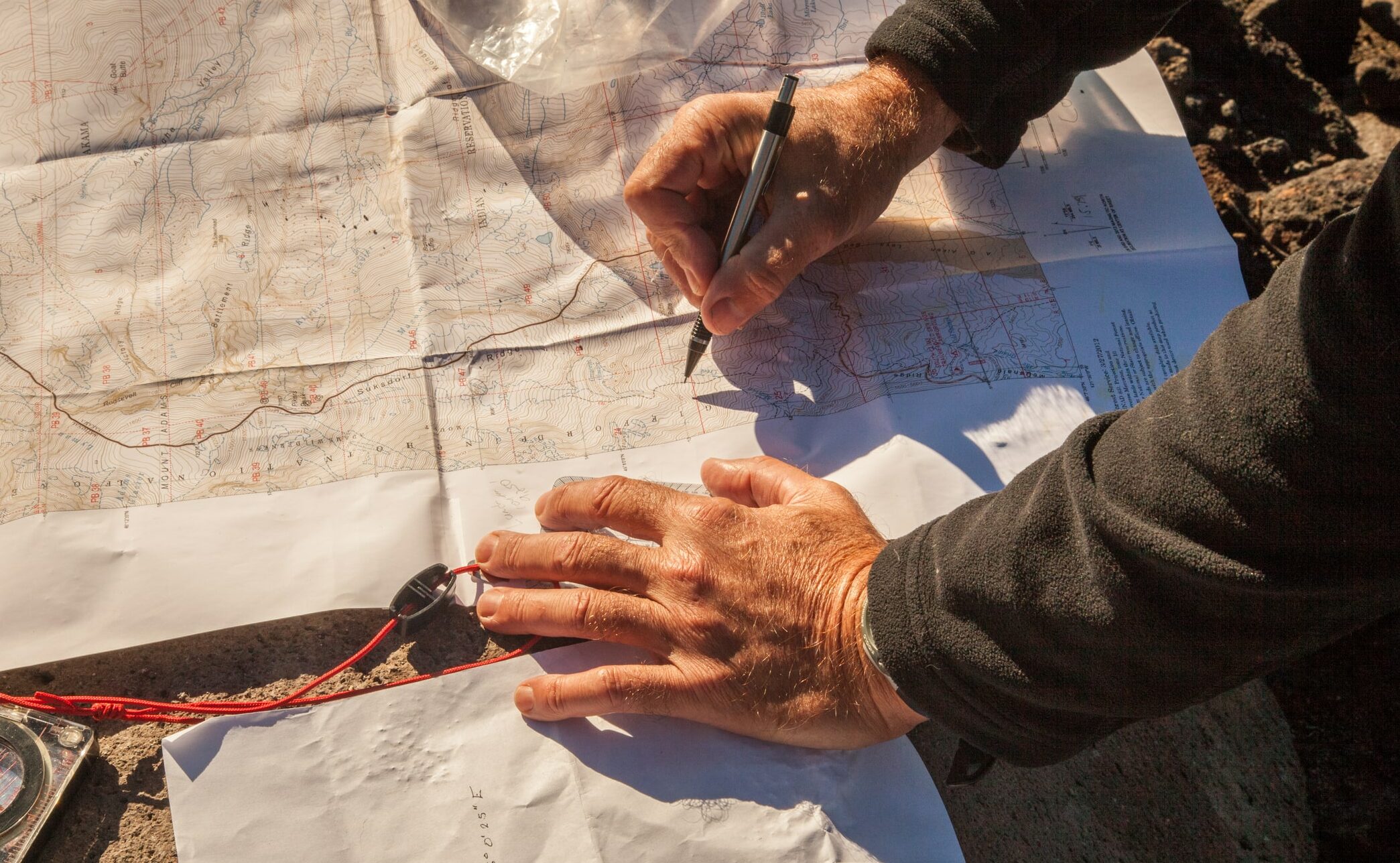 A hiker consults a topo map.