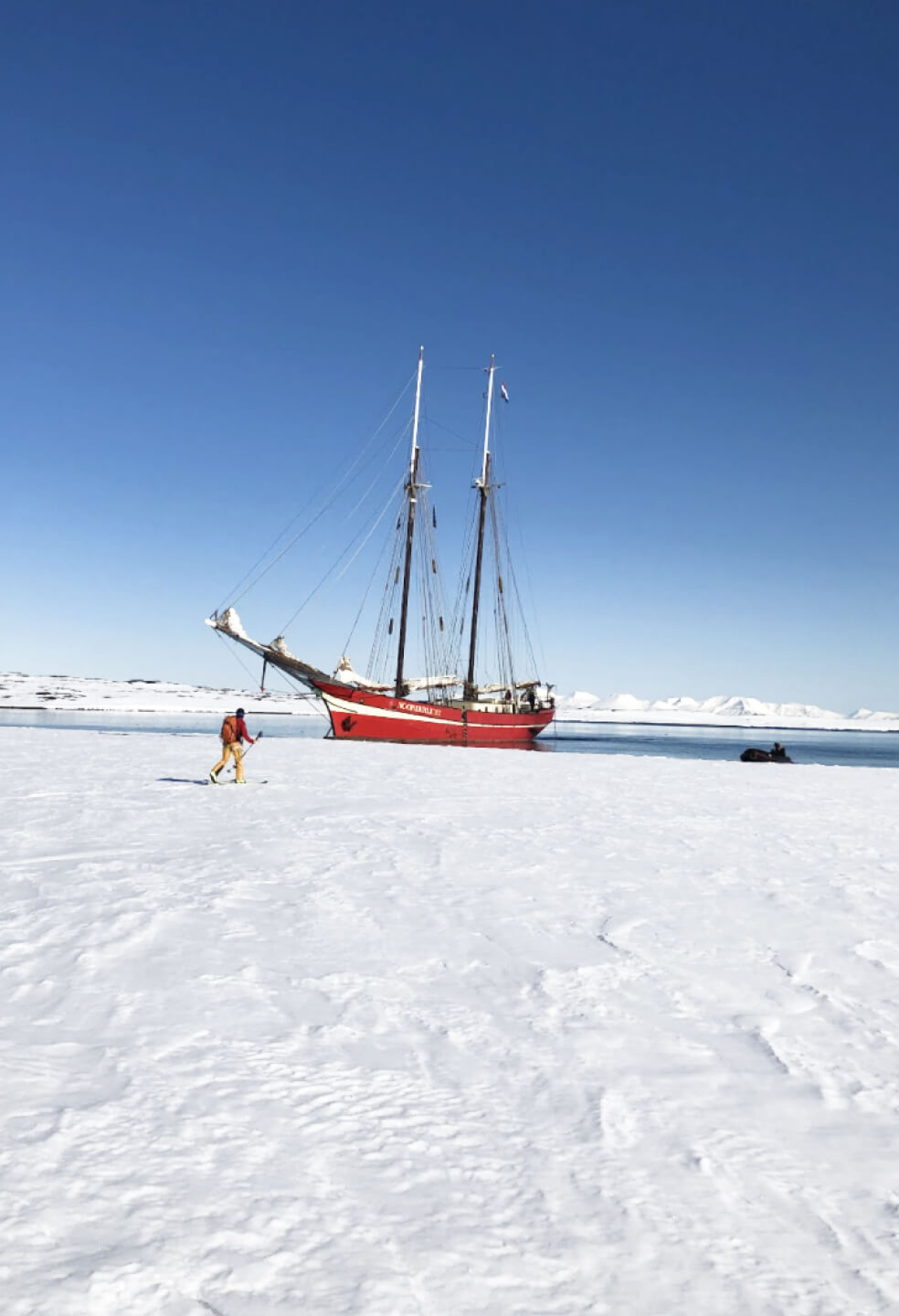 A sailboat docked at the ice in Svalbard.