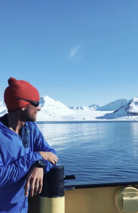 A sailor looking at the adventure coming ahead in Svalbard.